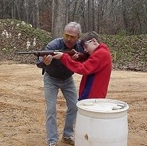 Gary at his home range teaching his son Yates how to shoot.